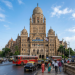 Mumbai Municipal Corporation building with buses, taxis, pedestrians, and Indian flags